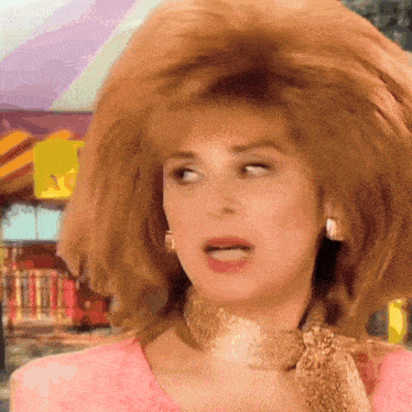 a woman wearing a choker and earrings has a very large haircut