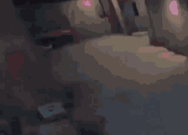 a couple of people are standing in a dark room .