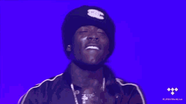 a man wearing a beanie with the number 20 on it looks up at the sky