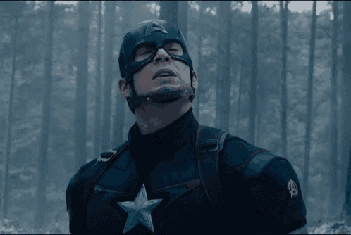 a man in a captain america costume is standing in the woods