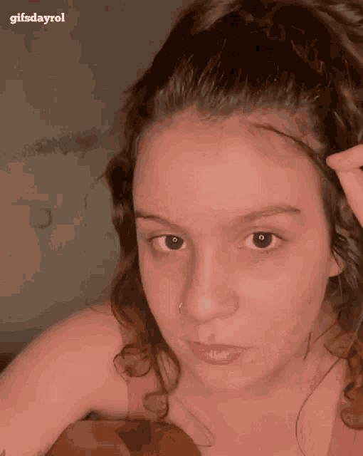 a close up of a woman 's face with the words gifsdayrol written above her