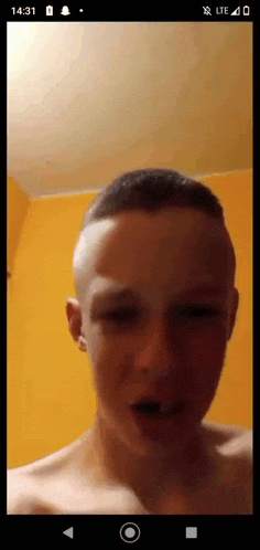 a phone screen shows a young man with his eyes closed
