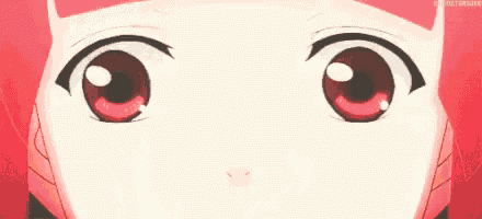 a close up of a girl 's face with red hair and red eyes .