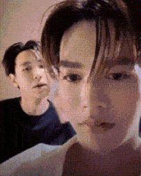 a close up of a person 's face with a blurred background of another person 's face .