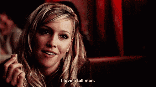 a woman says i love a tall man while holding a cigarette