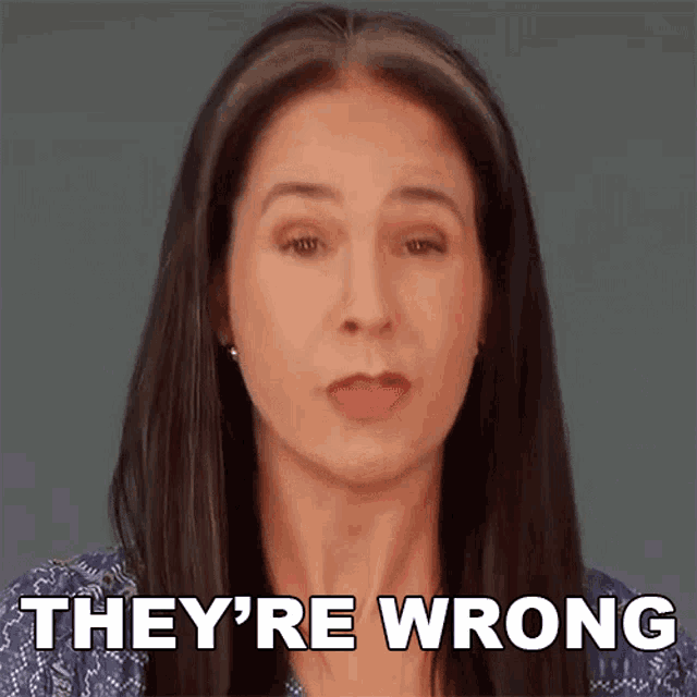 a woman says they 're wrong in front of a grey background .