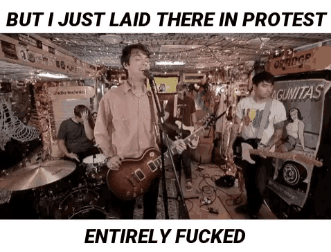 a man singing into a microphone while playing a guitar
