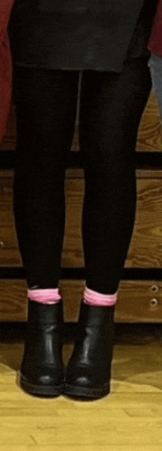 a person wearing black tights and pink socks