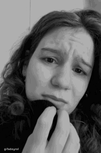 a woman 's face is shown in a black and white photo with gifsdayrol written below it