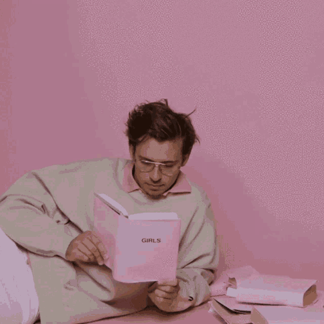 a man is reading a book called girls
