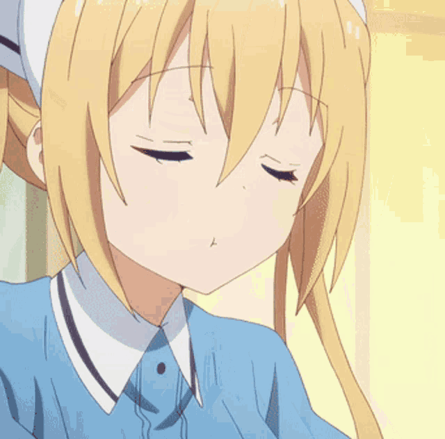 a girl with blonde hair and a blue shirt is making a funny face