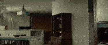 a kitchen with a white refrigerator and a blue lamp