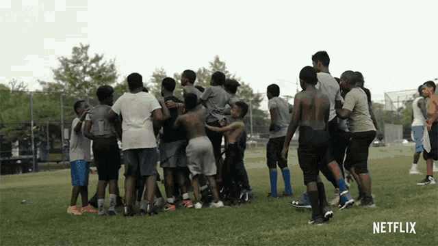 a group of boys are huddled together in a field with netflix written on the bottom