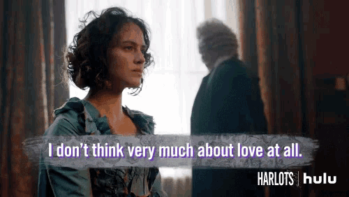 a woman in a blue dress says i don 't think very much about love at all while standing in front of a window