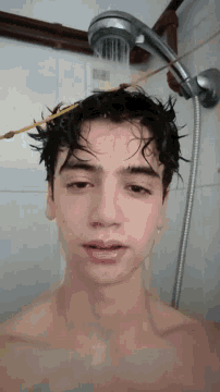 a man is taking a shower with a shower head hanging from his head