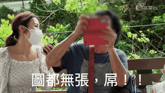 a man taking a picture of a woman with chinese writing