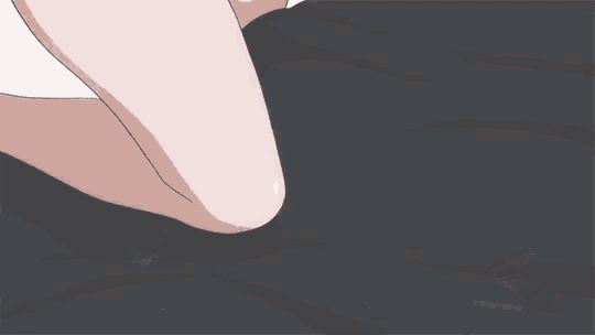 a couple of anime characters are laying on a bed with their feet crossed .
