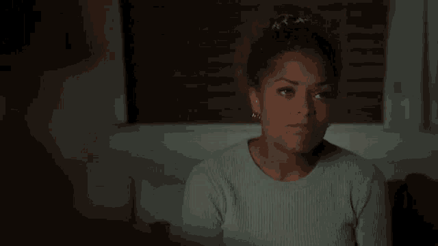 a woman is sitting on a couch and saying `` i think i 'm in love with my boss `` .