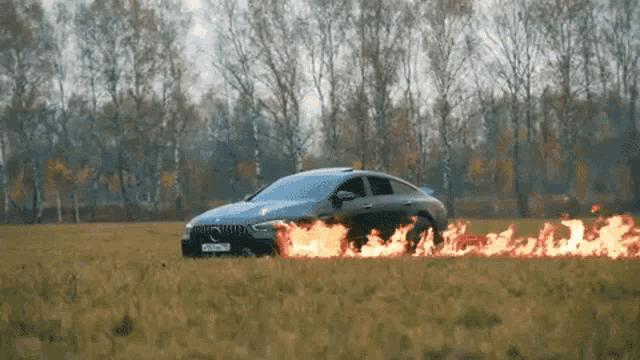 a car that is on fire in a field
