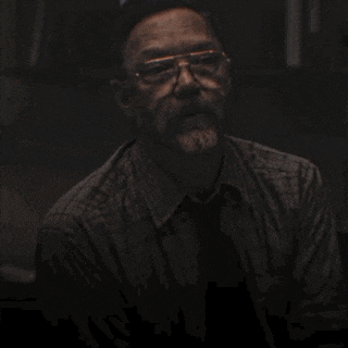 a man is sitting at a desk with the name william afton on the bottom