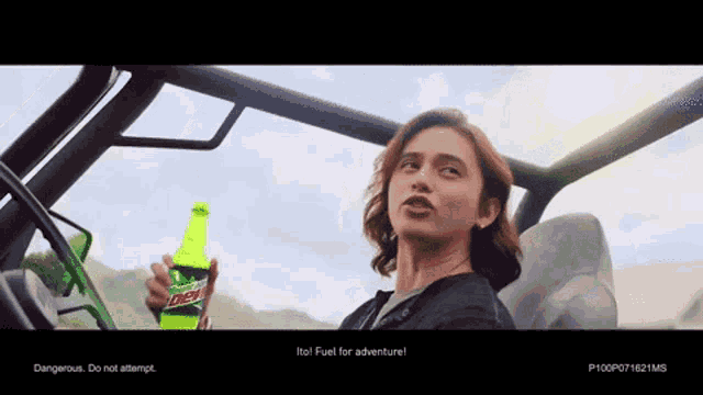 a man is holding a bottle of mountain dew