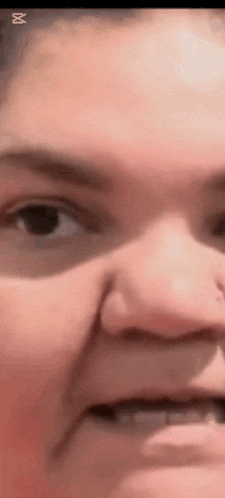 a close up of a person 's face with their mouth open and their eyes closed .
