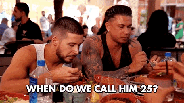 a group of men are sitting at a table eating food with the caption " when do we call him 25 " above them