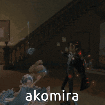 a man in a tuxedo is standing next to a woman in a blue dress with the word akomira on the bottom right