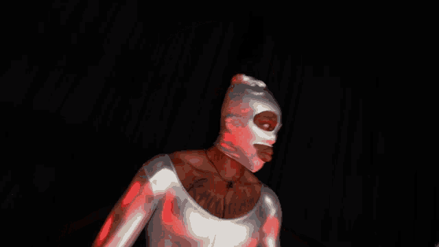 a man wearing a ski mask has a tattoo on his chest