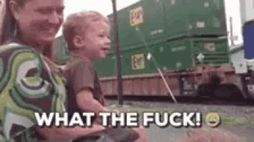 a woman is holding a baby in her arms and the baby is crying .