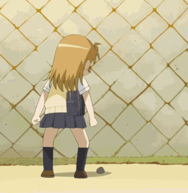 a girl in a school uniform kicking a ball