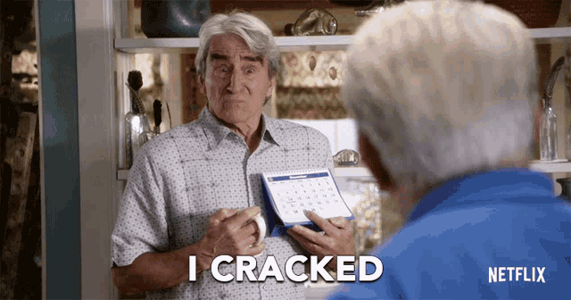 an older man is holding a calendar and says i cracked