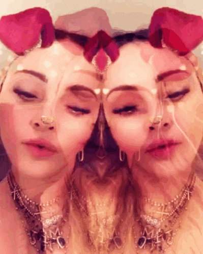 a close up of a woman 's face with roses on her head and a necklace that says amour