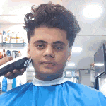 a man is getting his hair cut by a barber in a barber shop .