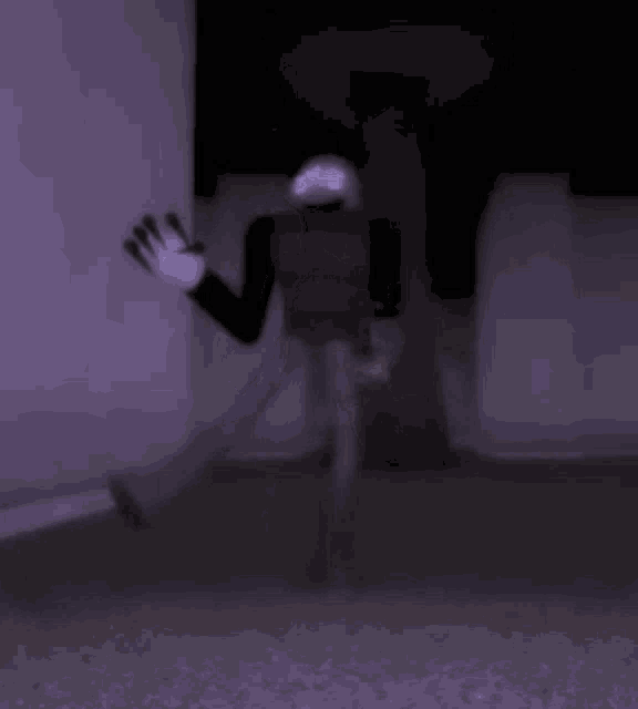 a person in a rabbit costume is standing in a dark room with a purple background .