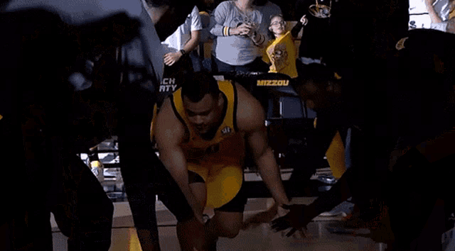 a basketball player in a yellow jersey with the number 10 on it