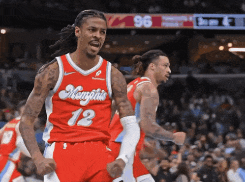 a basketball player wearing a red jersey with memphis 12 on it