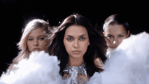 three women standing next to each other with smoke coming out of them