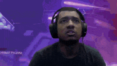 a man wearing headphones looks up at something in the sky