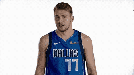 a basketball player wearing a dallas jersey makes a funny face