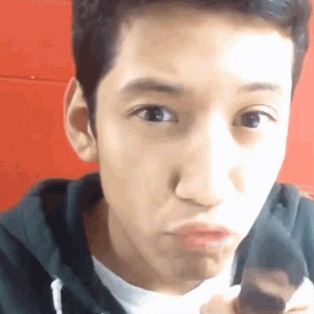 a close up of a young man making a face with his mouth open
