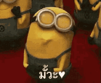 a group of minions are standing next to each other and one of them has a heart on his chest