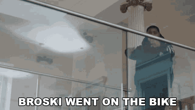 broski went on the bike is written on a glass railing
