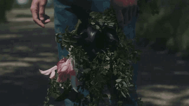 a person is holding a bouquet of flowers in their hands