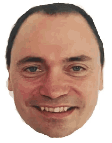 a close up of a man 's face smiling with a white background