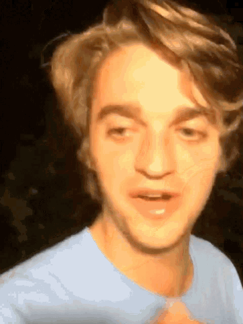 a close up of a young man 's face with a blurred background