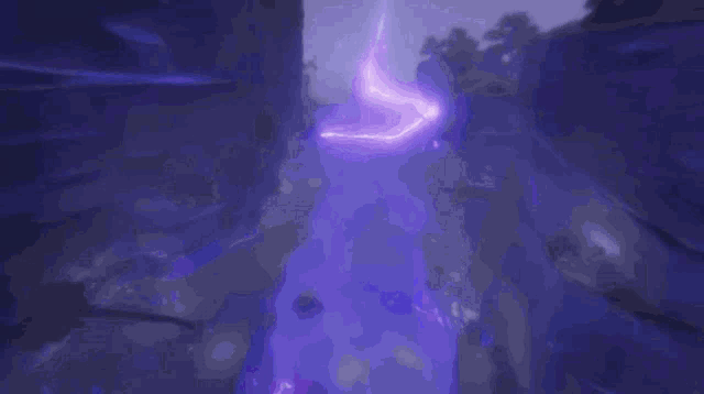 a purple light is coming out of a purple object in a dark room .