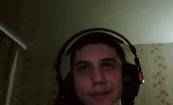a man wearing headphones looks at the camera