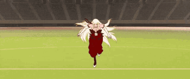 a girl in a red dress is running on a field