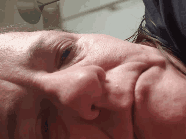 a close up of a woman 's face with a spoon in her hair
